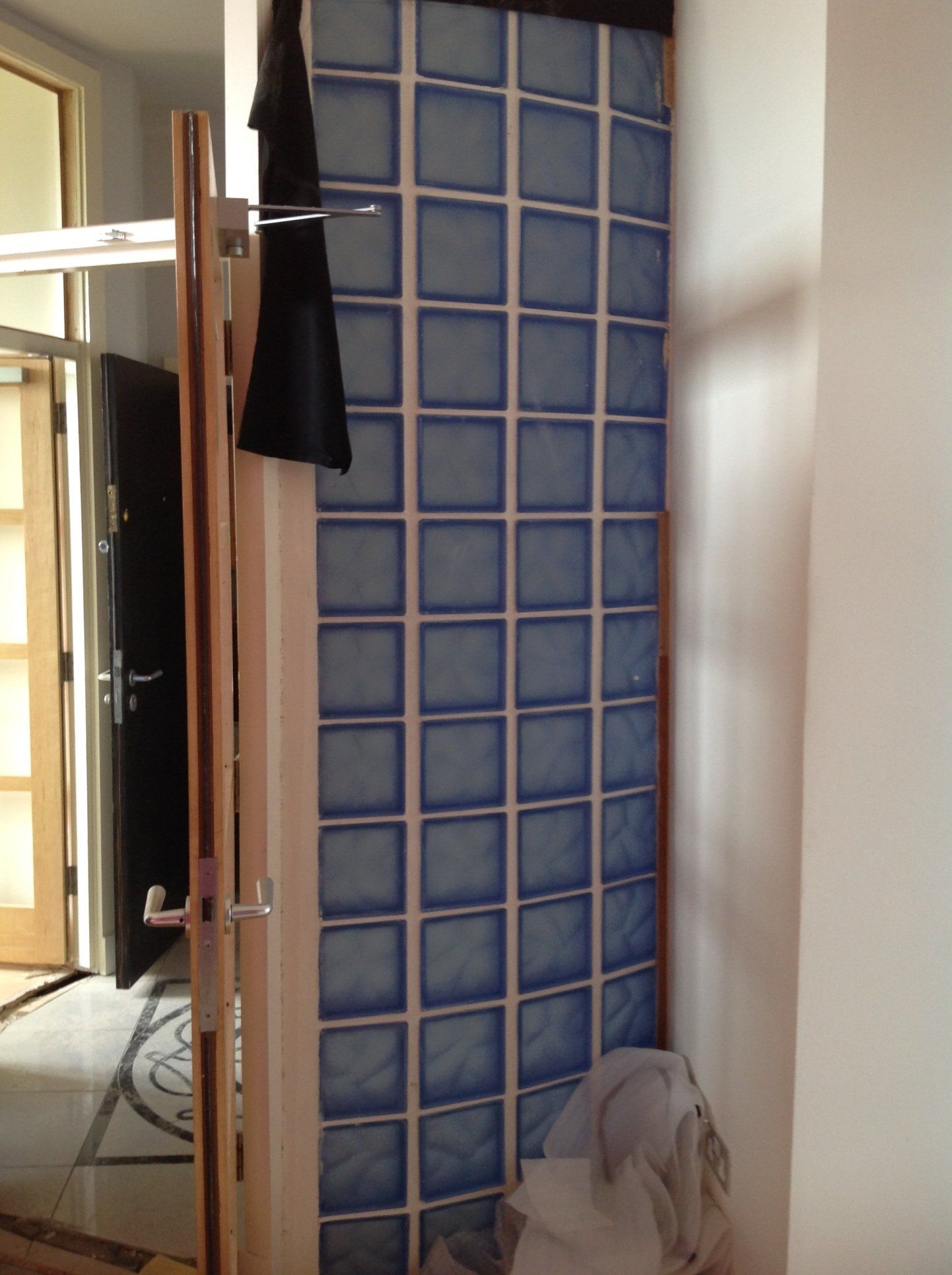A room with blue blocks on the wall and a door