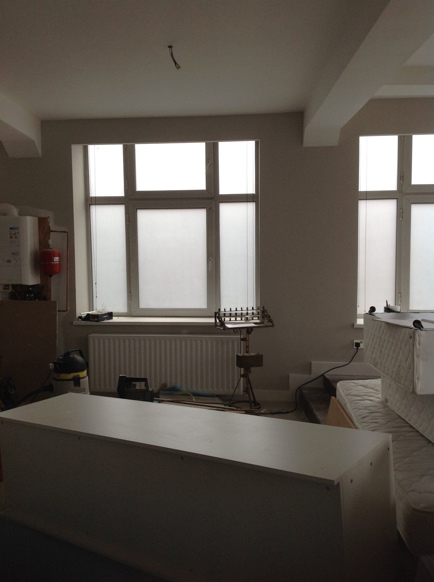 A room with a lot of windows and a white table