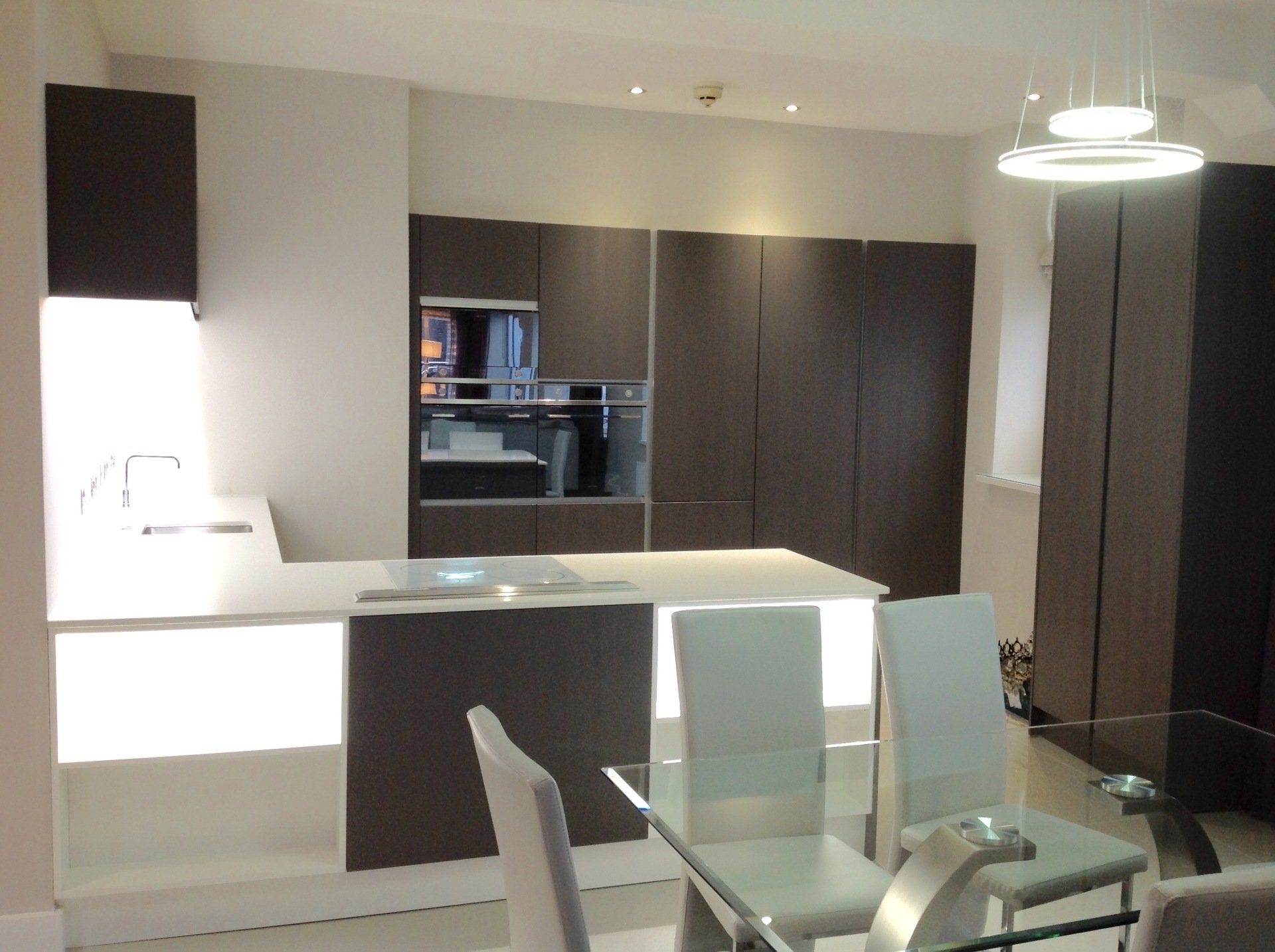 A kitchen with a table and chairs in it