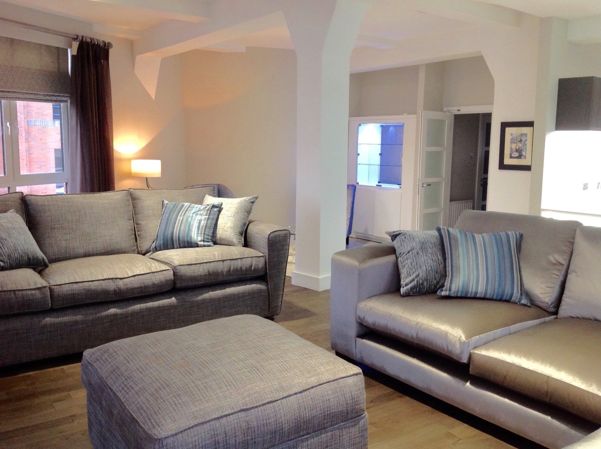 A living room with two couches and an ottoman