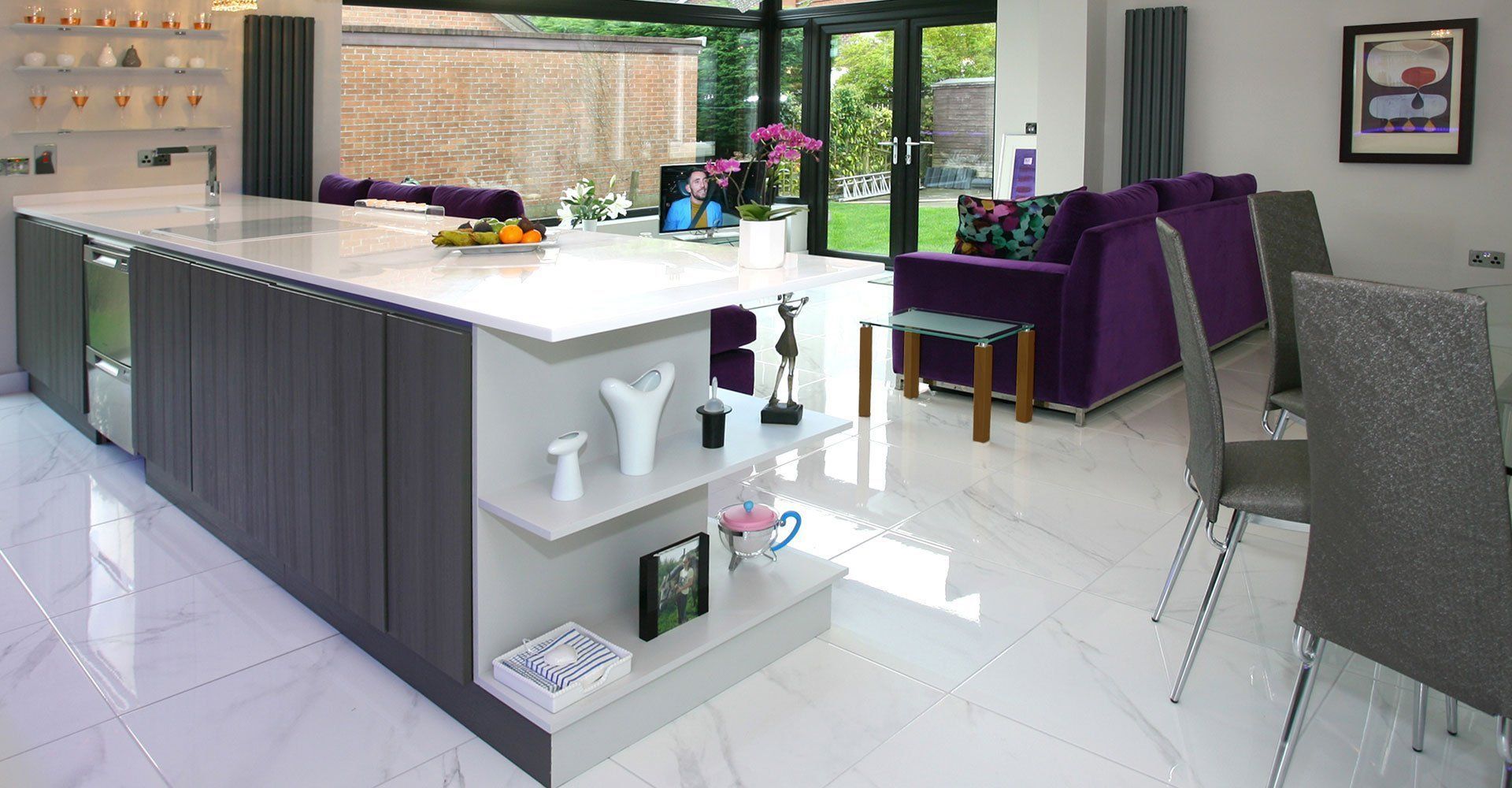 A kitchen with a large island and a purple couch