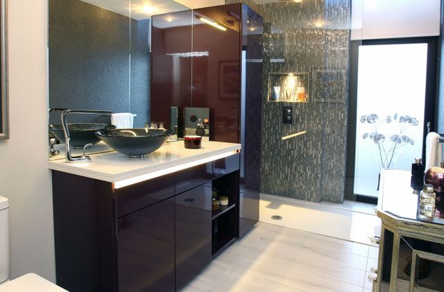 A bathroom with a sink , toilet and shower.