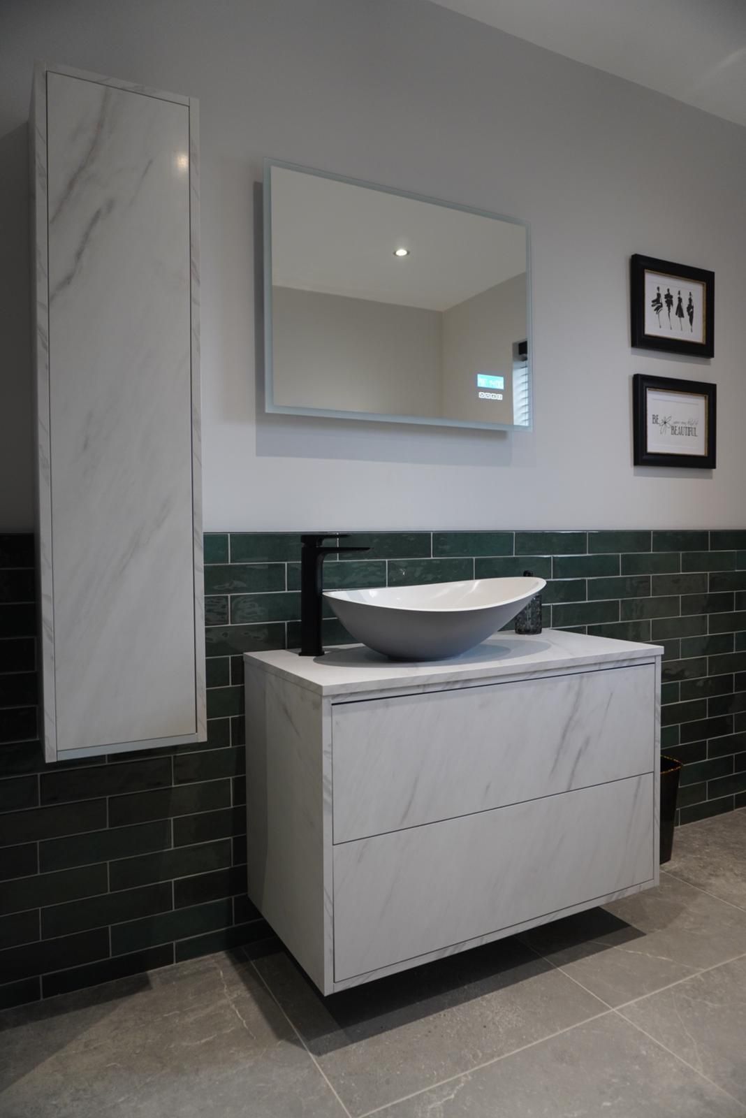 A bathroom with a sink , mirror and cabinets.