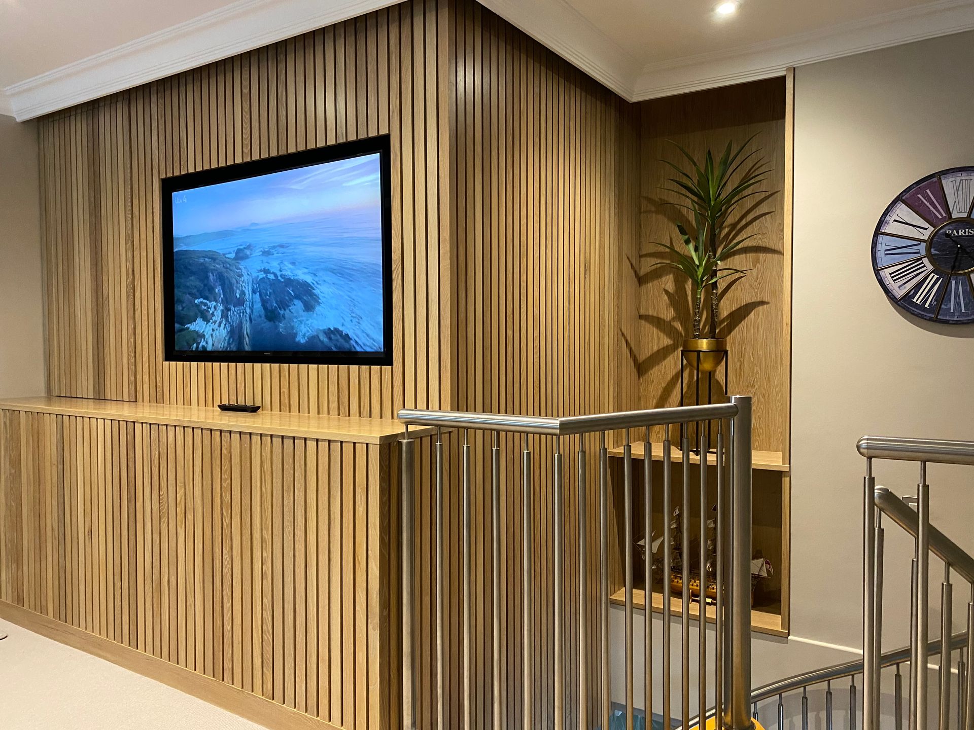 A wooden wall with a flat screen tv mounted on it.