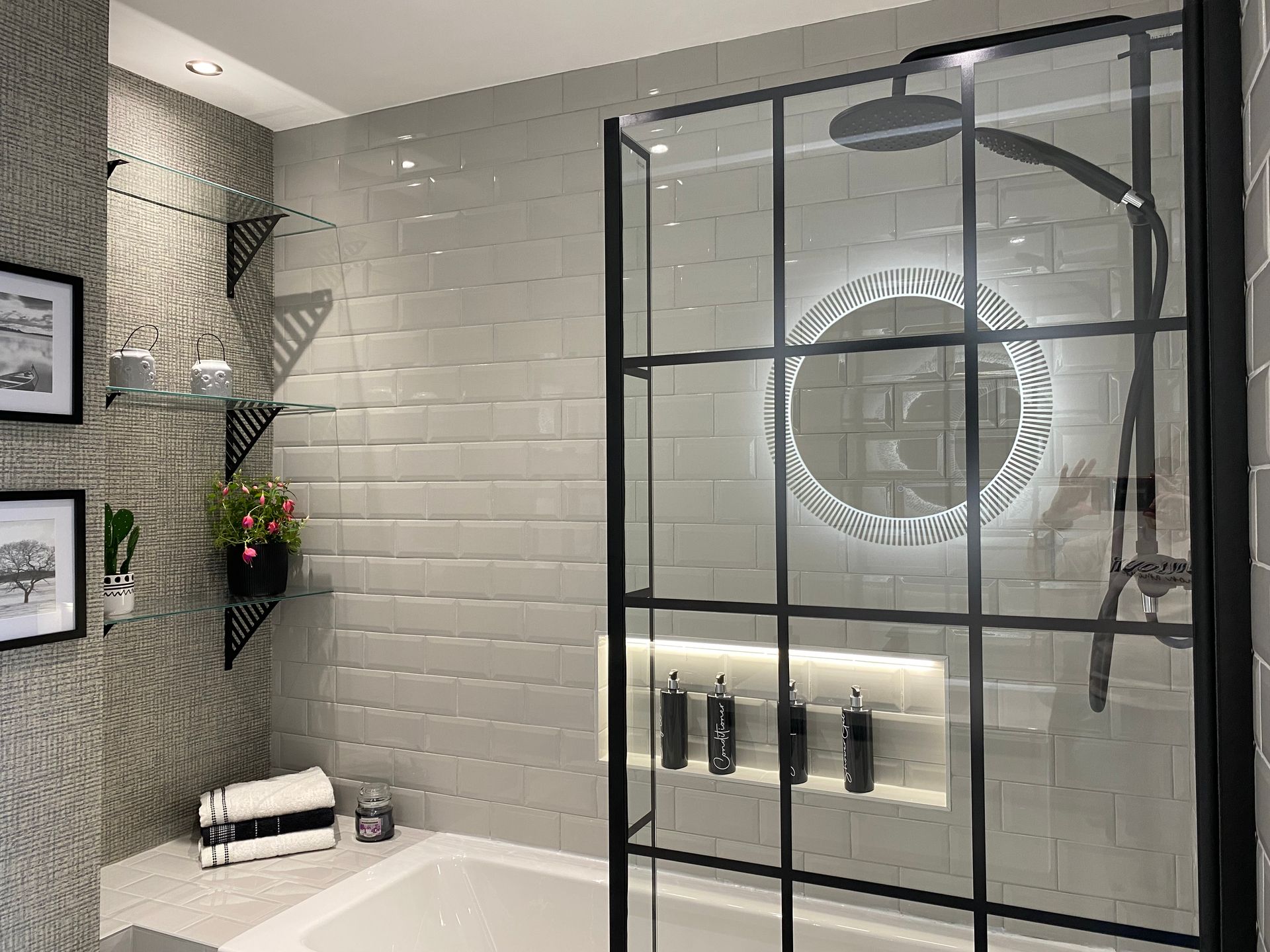 A bathroom with a walk in shower and a mirror.