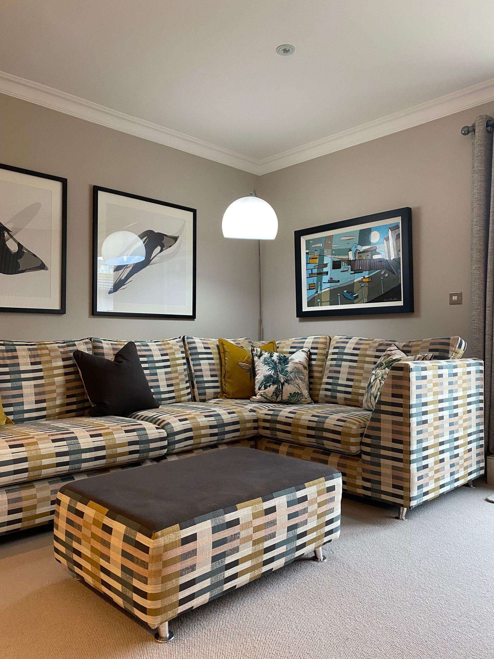 A living room with a sectional couch and a coffee table.