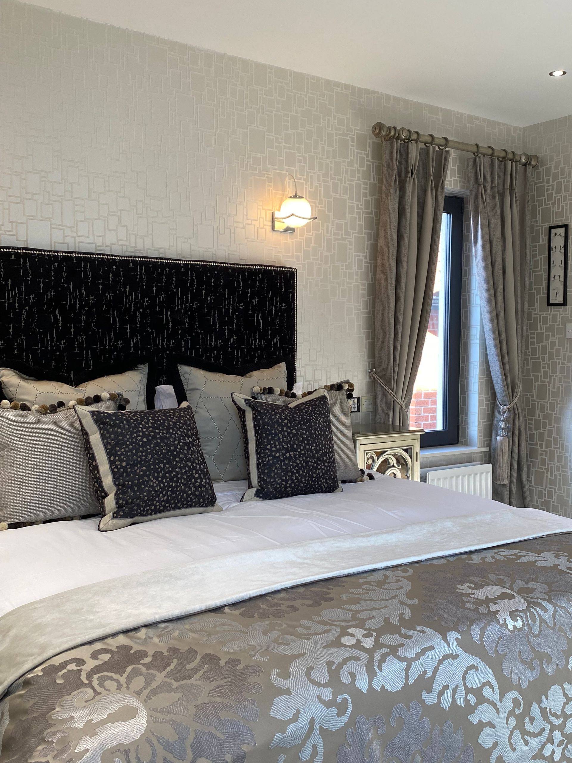 A bedroom with a large bed and a window.