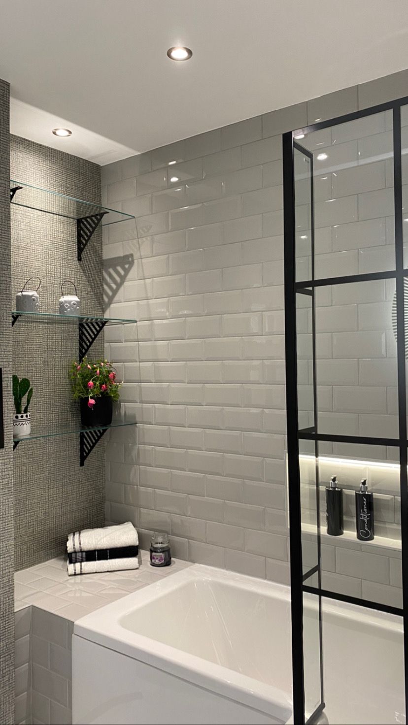 A bathroom with a bathtub and a shower stall.