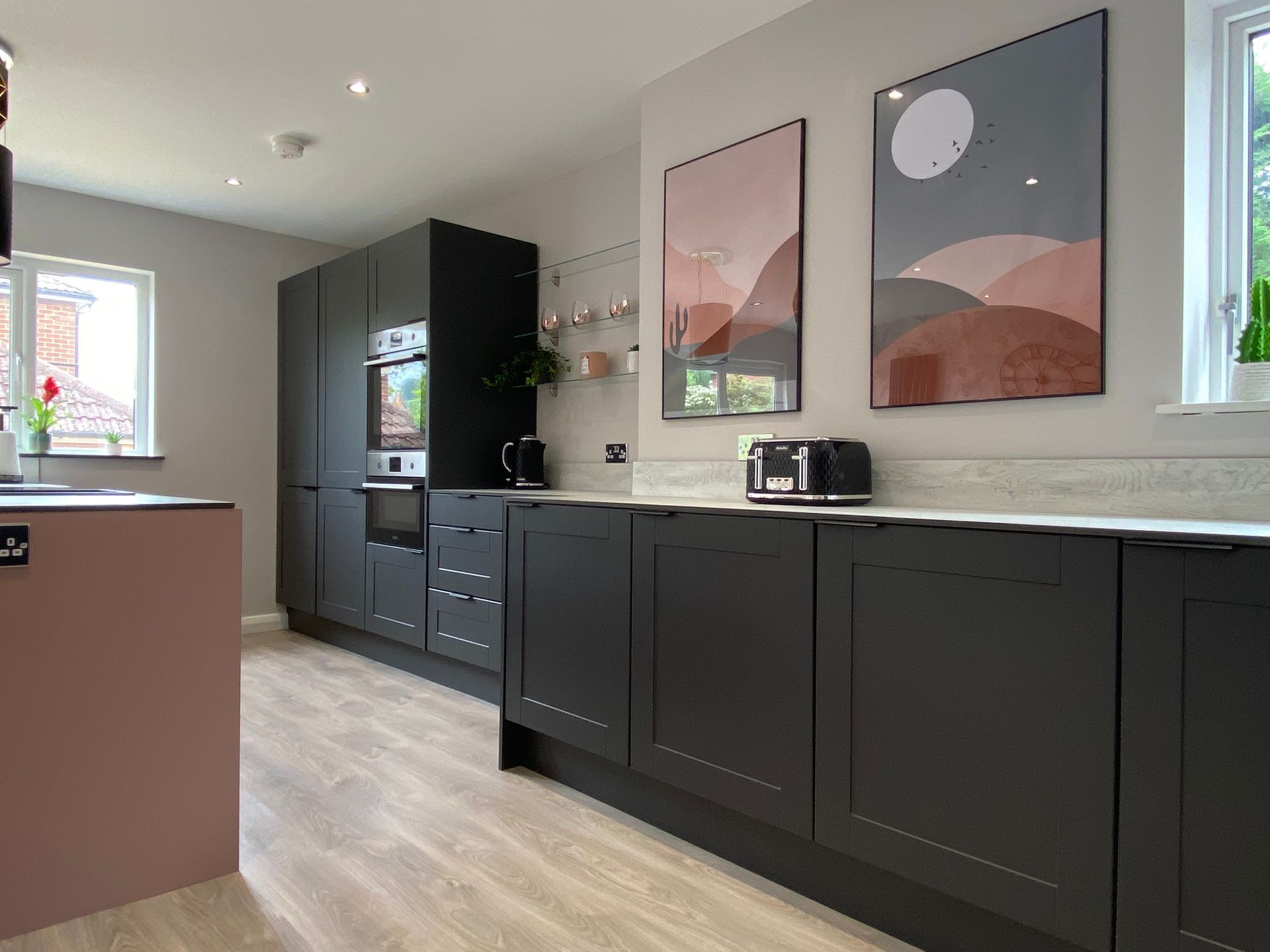 A kitchen with a lot of cabinets and a toaster oven.