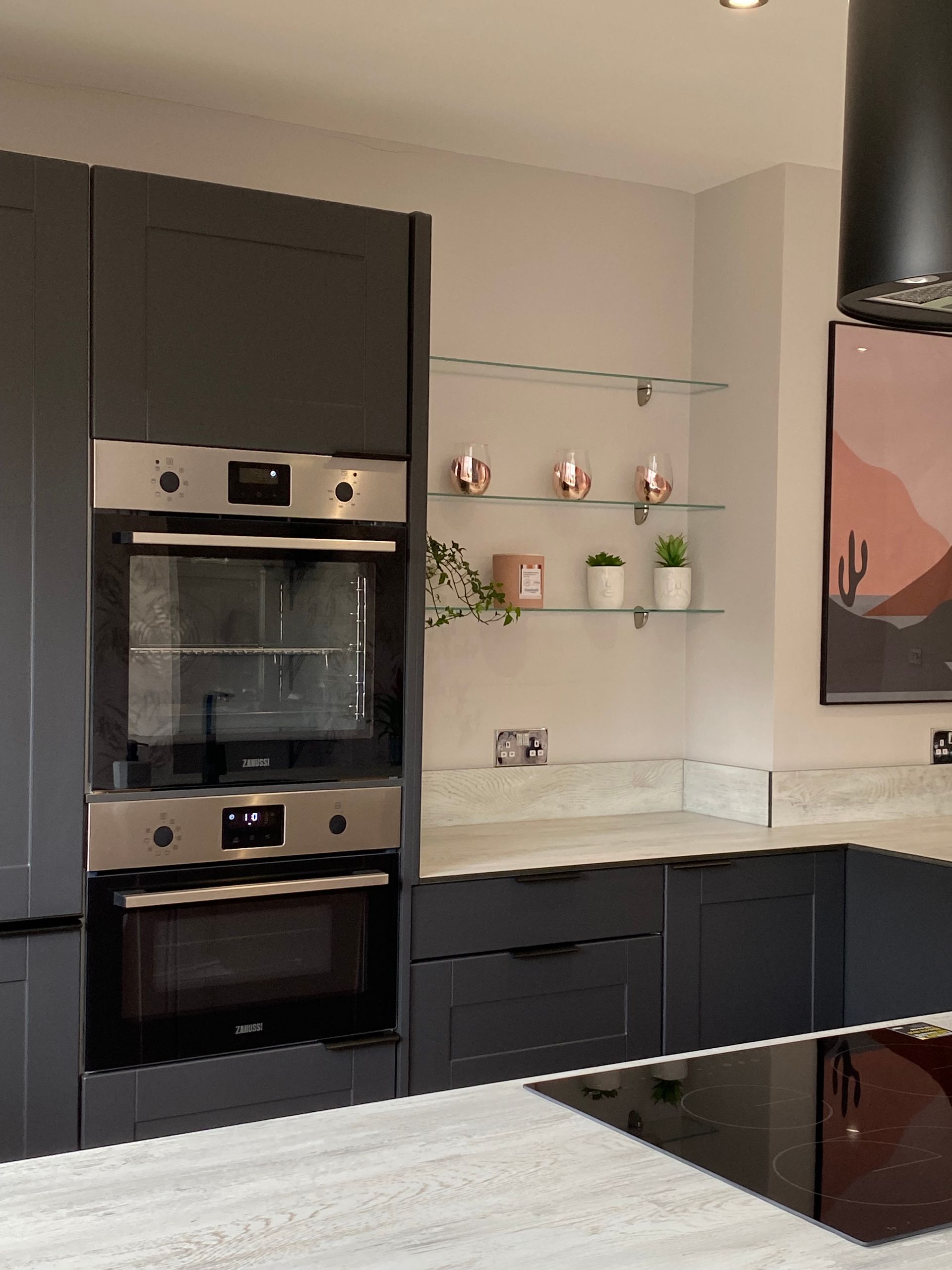 A kitchen with black cabinets and a stove top oven