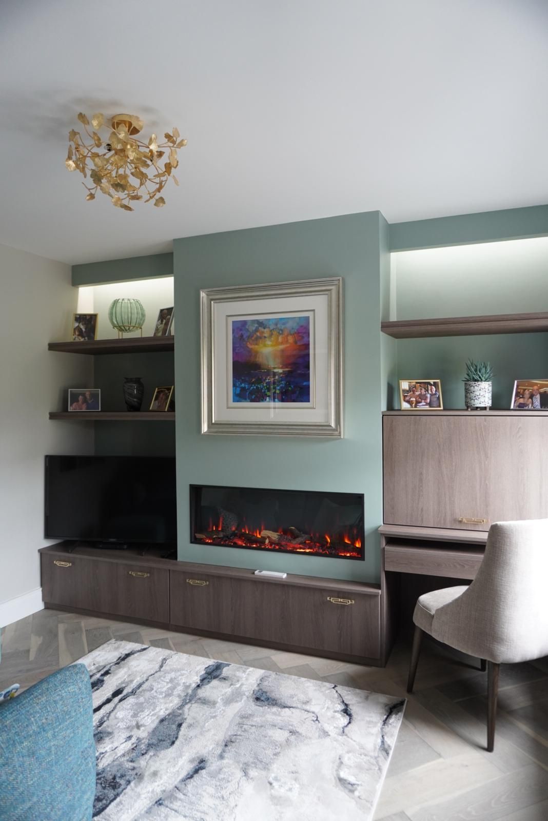 A living room with a fireplace and a painting on the wall.