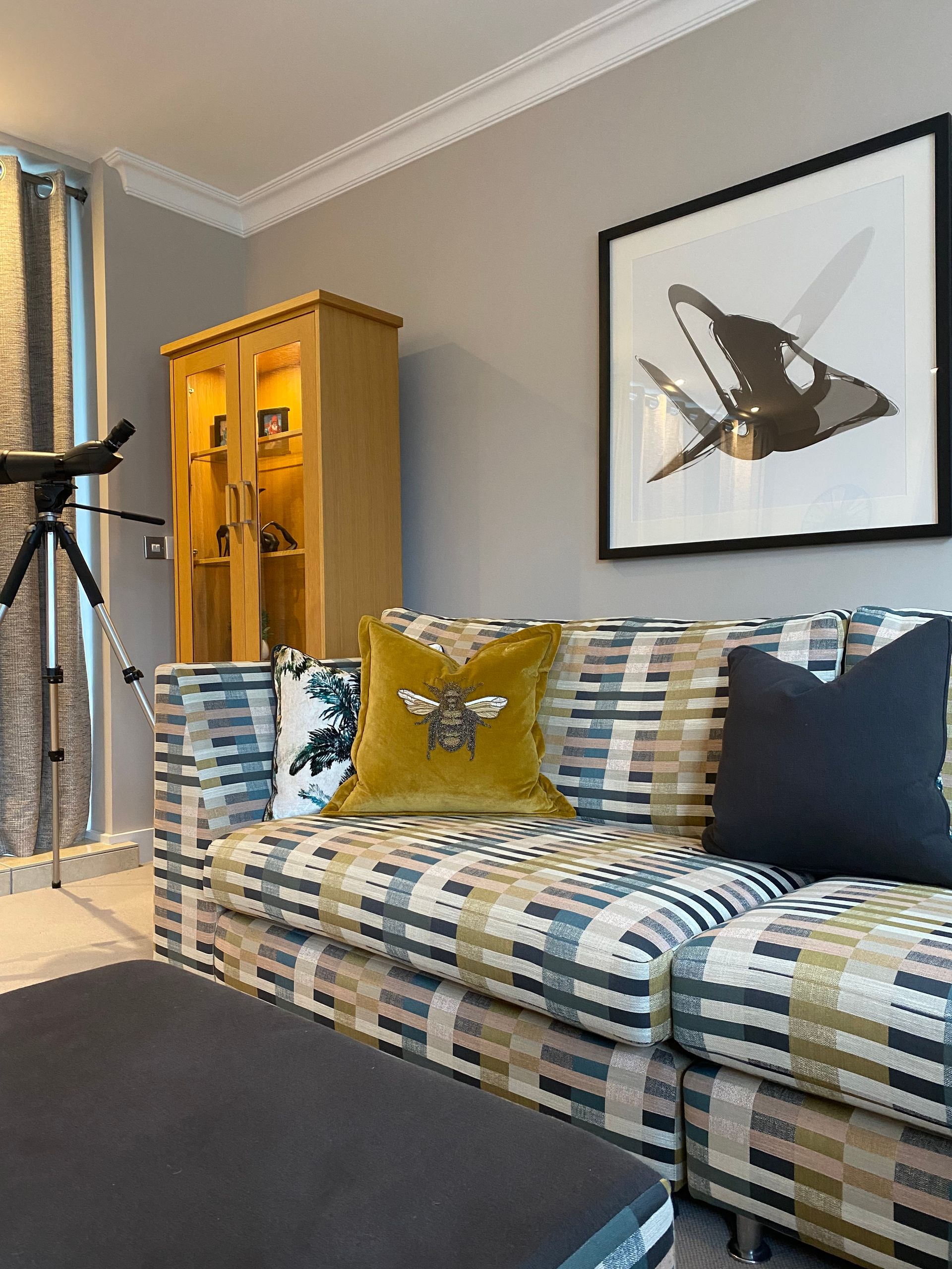 A living room with a couch and a picture on the wall