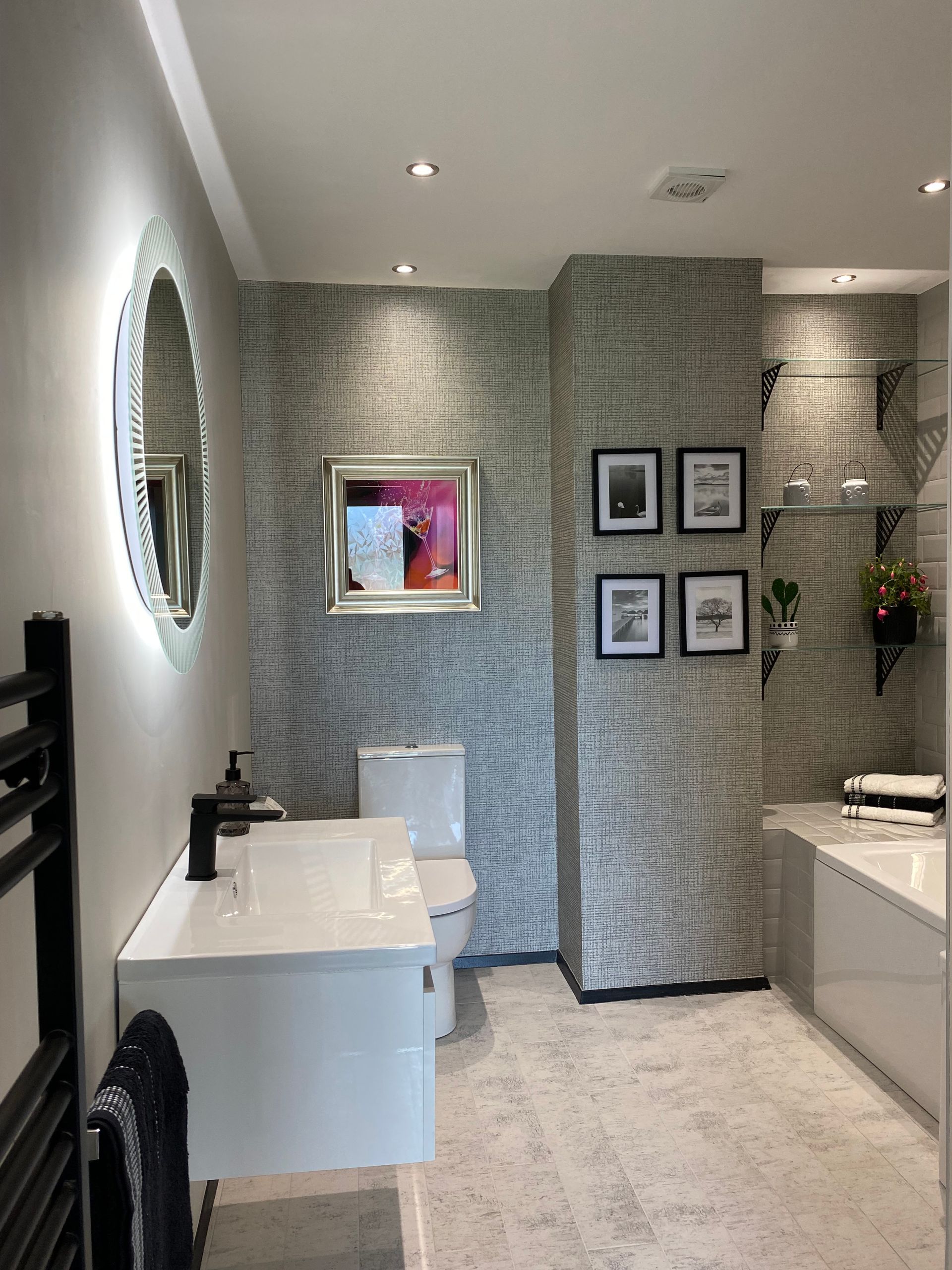 A bathroom with a sink , toilet , mirror and bathtub.