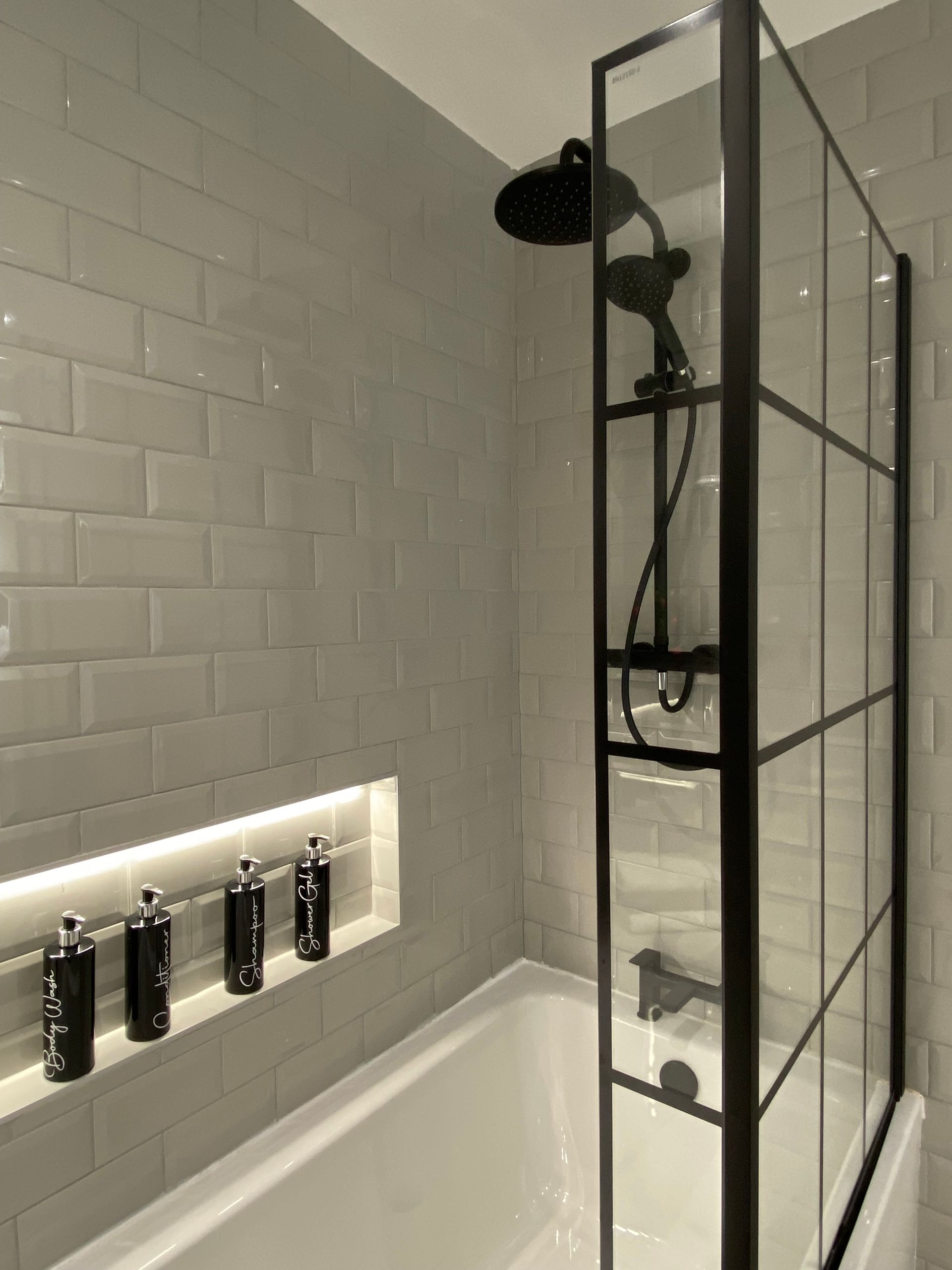 A bathroom with a bathtub and a shower stall