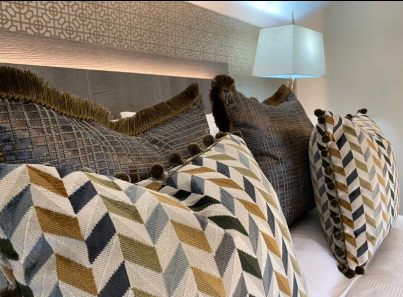 A bed with a lot of pillows on it