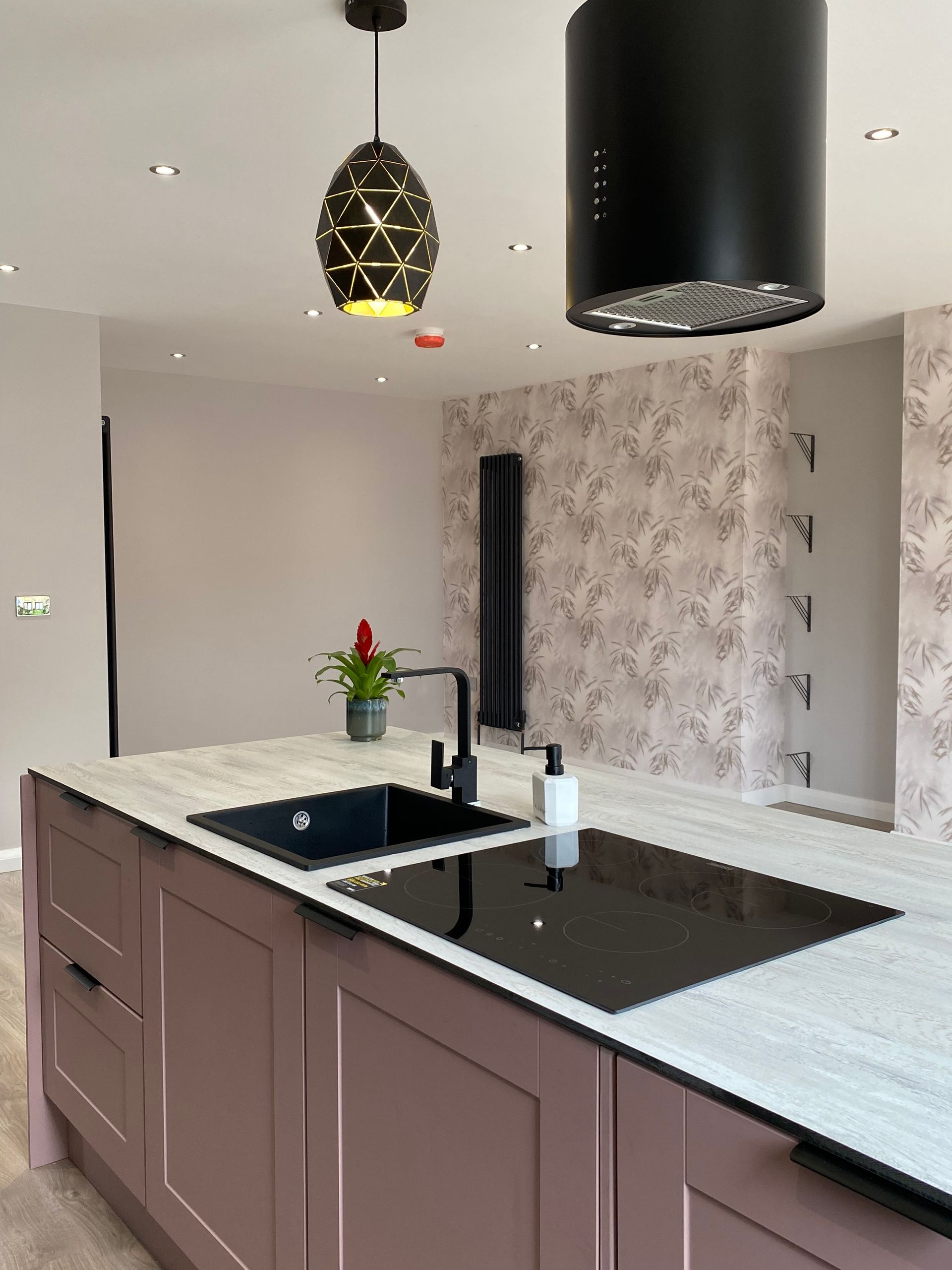 A kitchen with a sink and a stove top oven