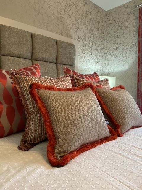 A bed with a headboard and pillows on it