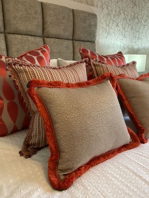 A bed with a lot of pillows on it