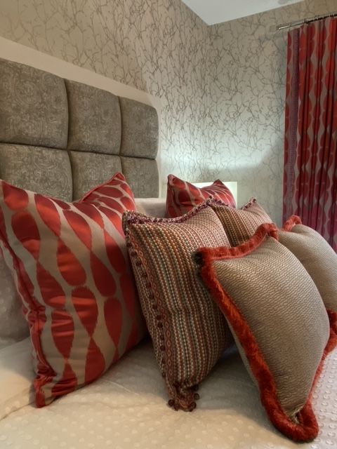 A bed with a lot of pillows on it