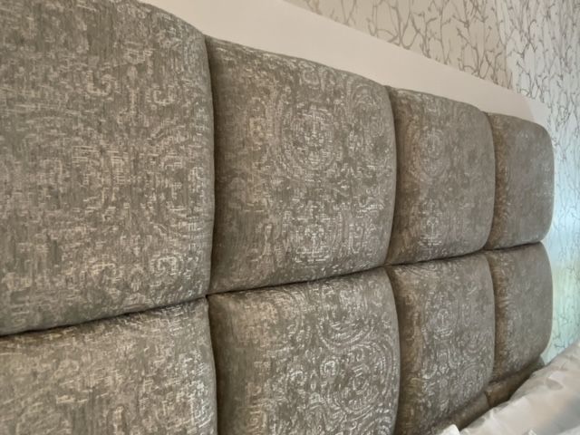 A close up of a bed headboard in a bedroom.
