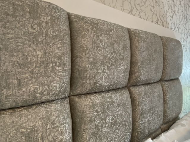 A close up of a bed headboard in a bedroom.