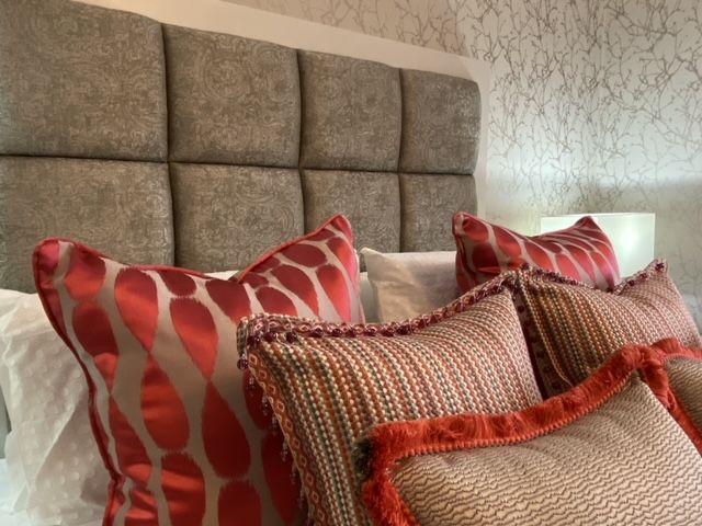 A bed with a headboard and pillows on it