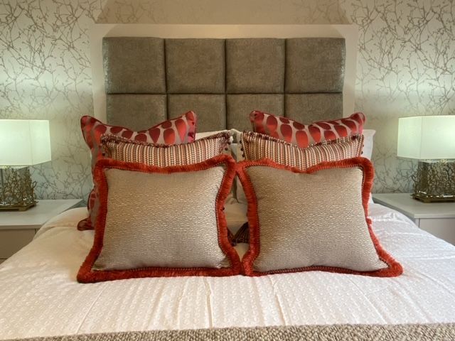 A bed with a headboard and two pillows on it