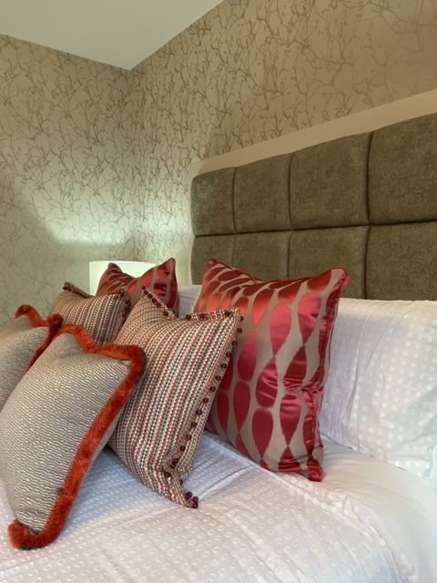 A bed with a headboard and pillows on it