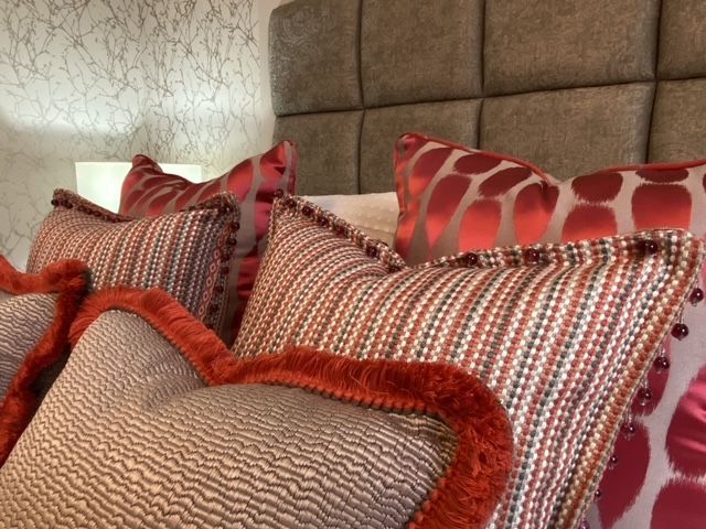 A bed with a lot of pillows on it