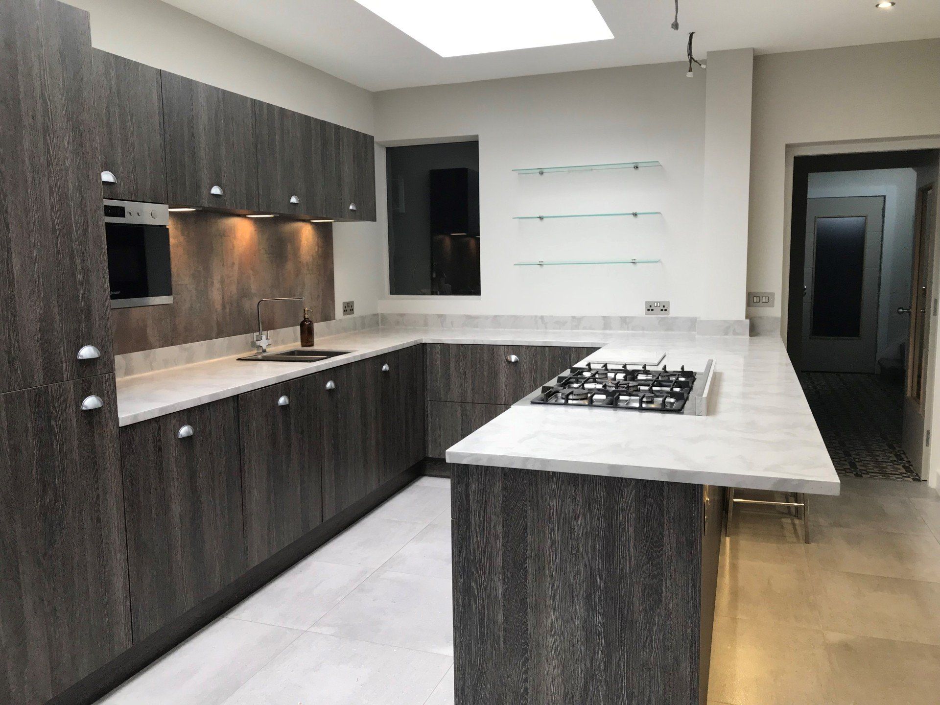 A kitchen with a stove top oven and a sink
