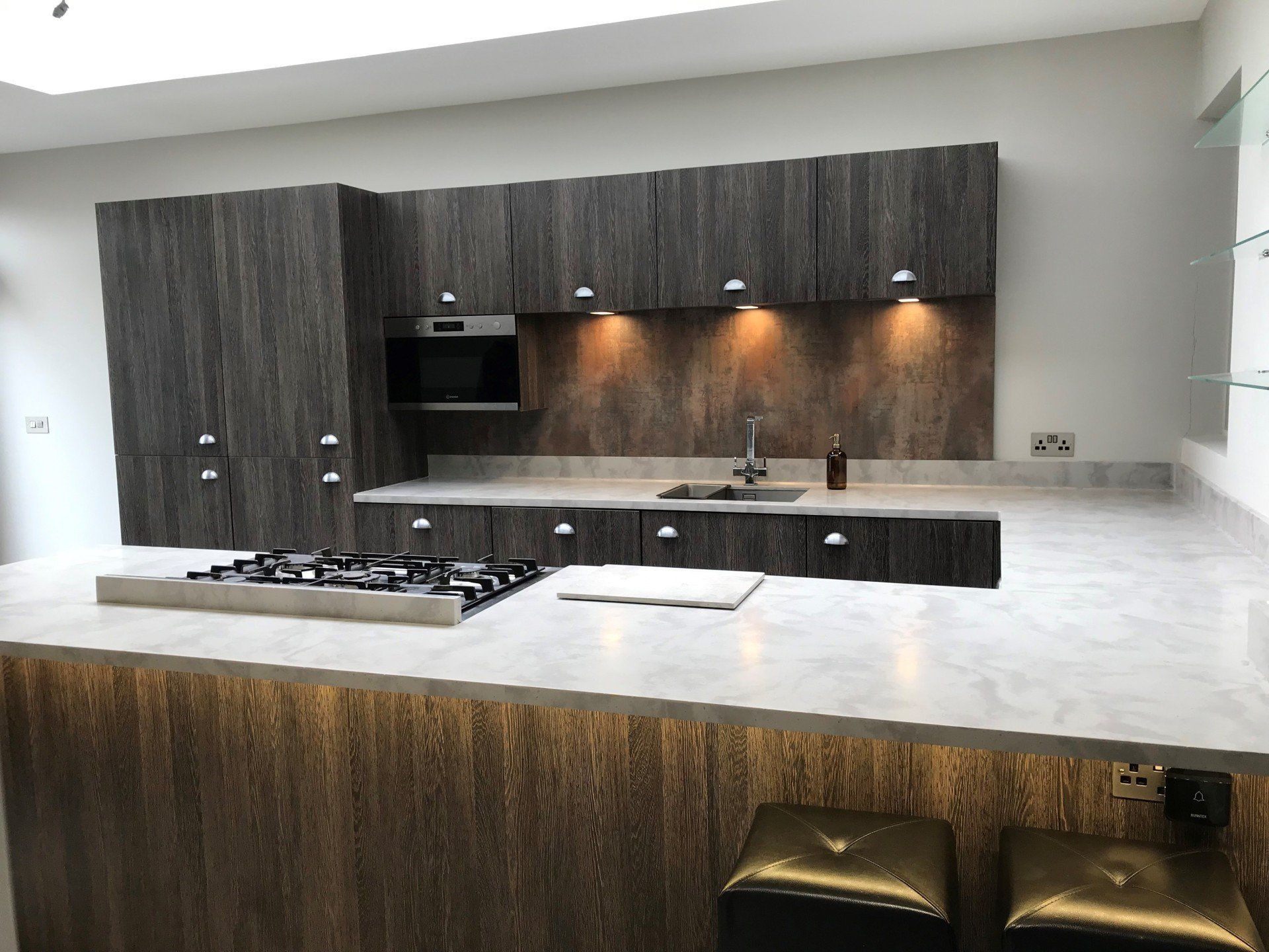 A kitchen with wooden cabinets and a stove top oven.