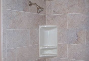 inside shower with shower head and soap holder
