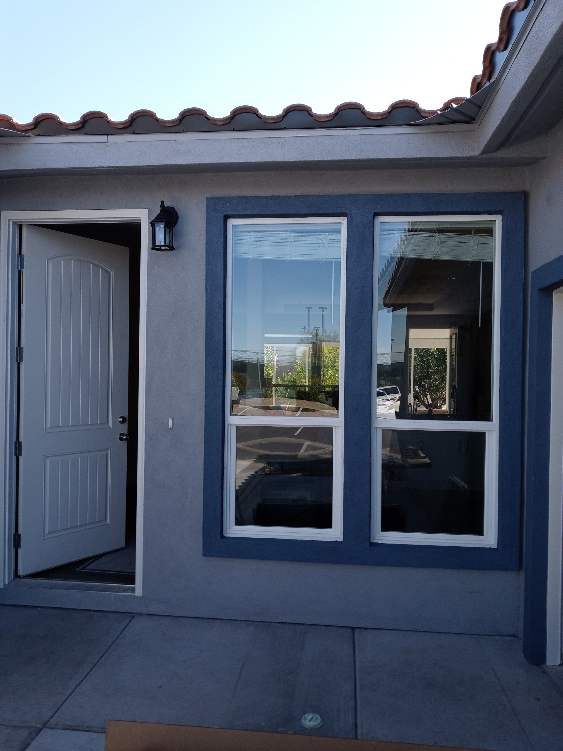 A house with a white door and blue windows