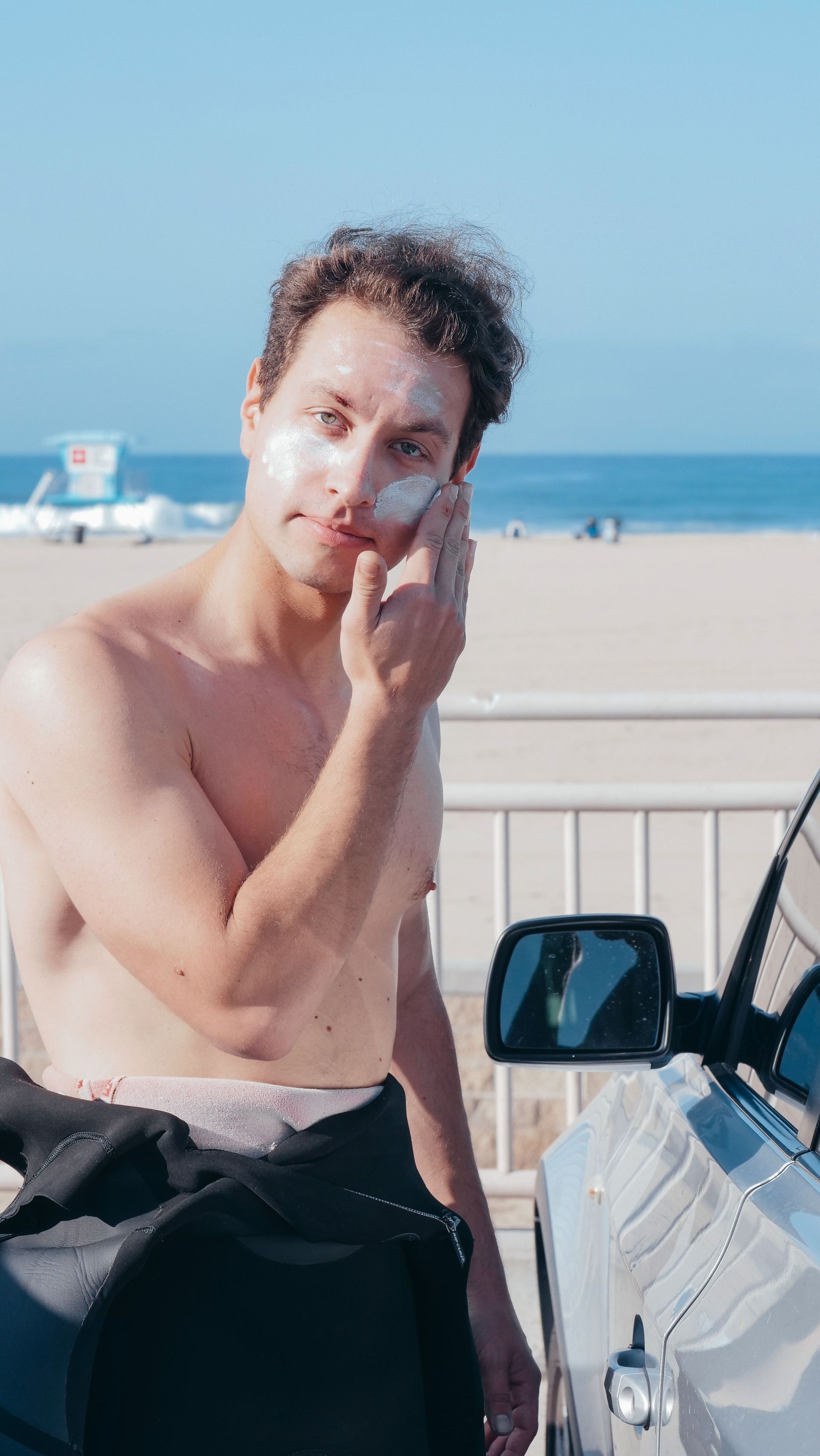 Man putting on sunscreen.