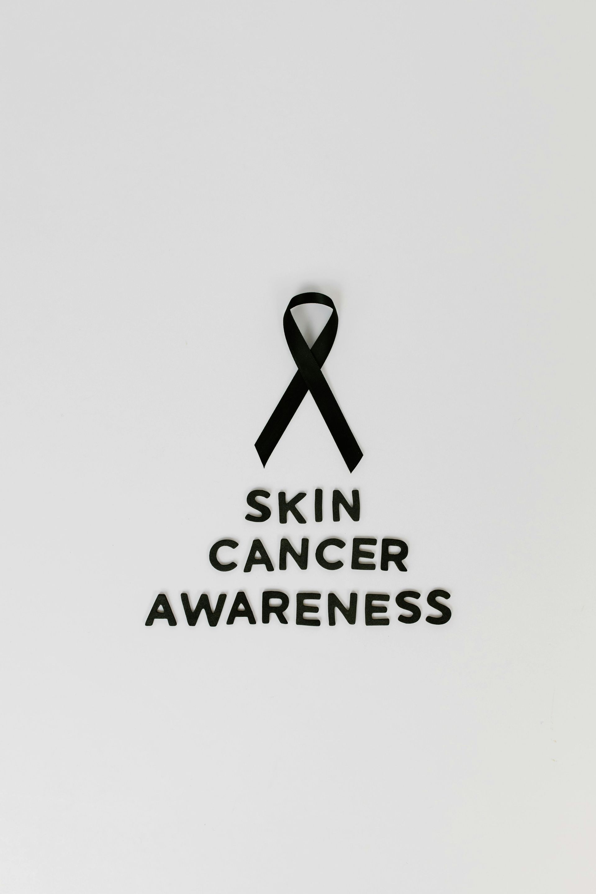 Black ribbon symbol for Skin Cancer Awareness on a white background.