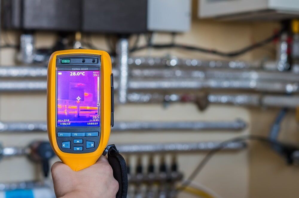 A Person Holding a Yellow Thermal Imaging Camera to Inspect Plumbing — Leak & Co in Zuccoli, NT