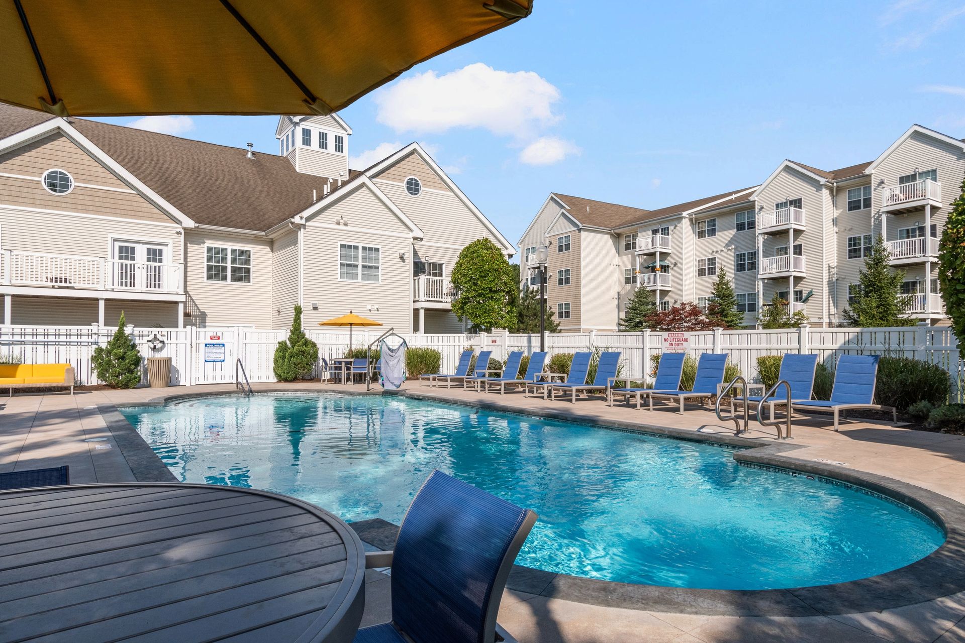 Independence Place apartment community outdoor pool with poolside lounge.