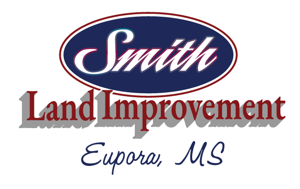 Yellow and black logo for Smith Land Improvements featuring an excavator.