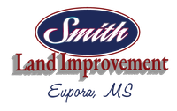 Yellow and black logo for Smith Land Improvements featuring an excavator.
