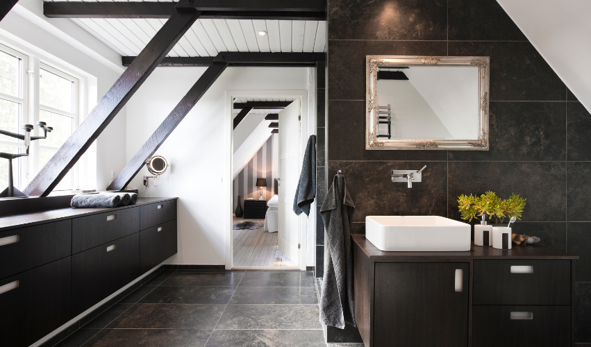 A bathroom with a toilet , sink , mirror and walk in shower.