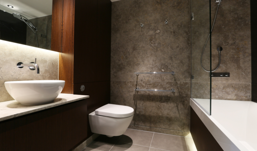 A bathroom with two sinks , a mirror and a walk in shower.