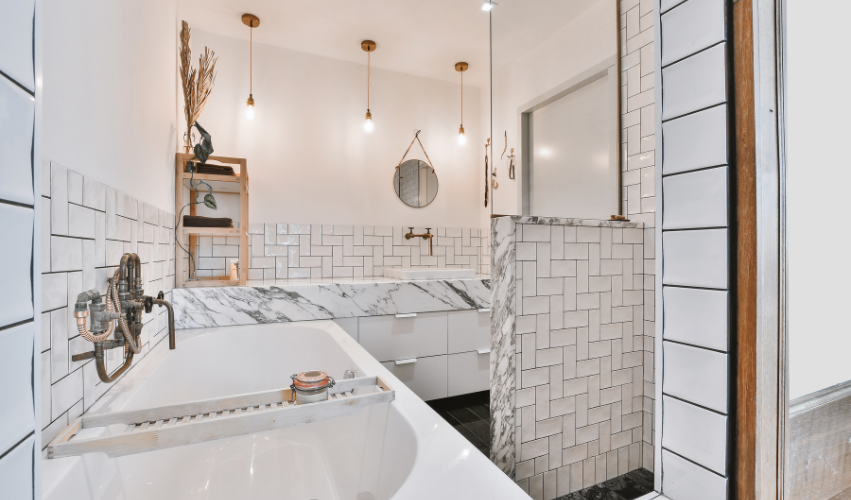 A bathroom with two sinks , a toilet , and a walk in shower.