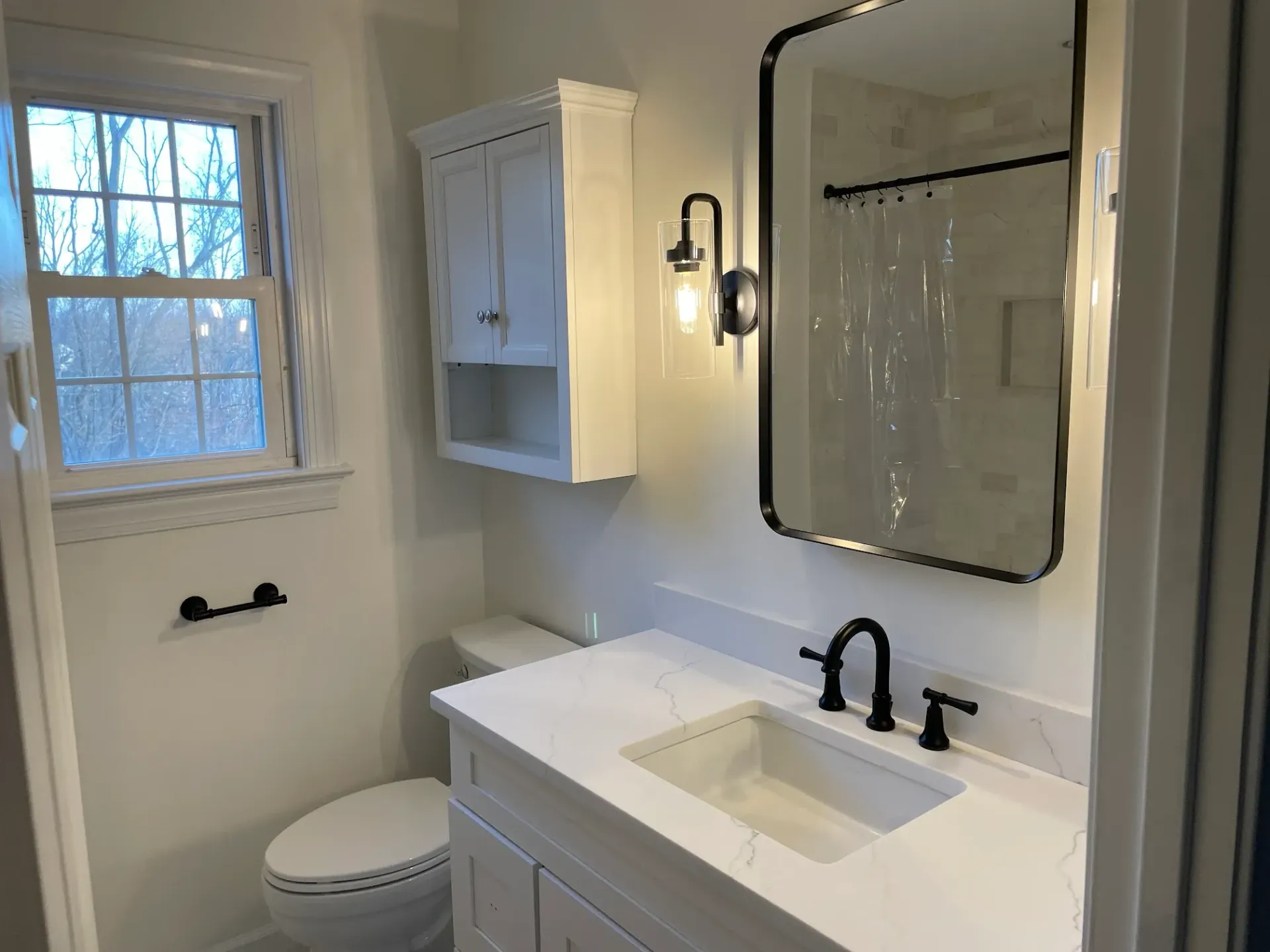 Modern Bathroom with a White Vanity and Black Fixtures