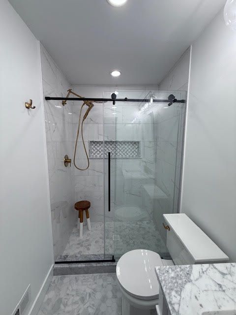 A Bathroom with a glass shower door
