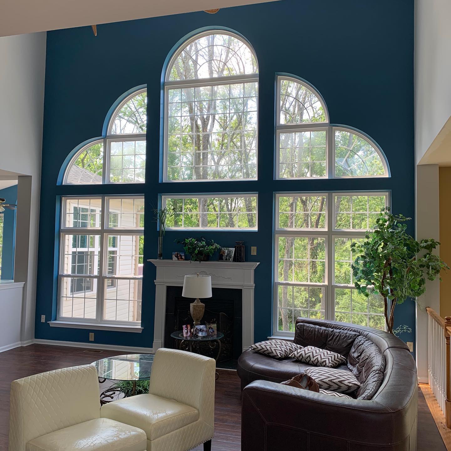 A living room with blue walls and lots of windows
