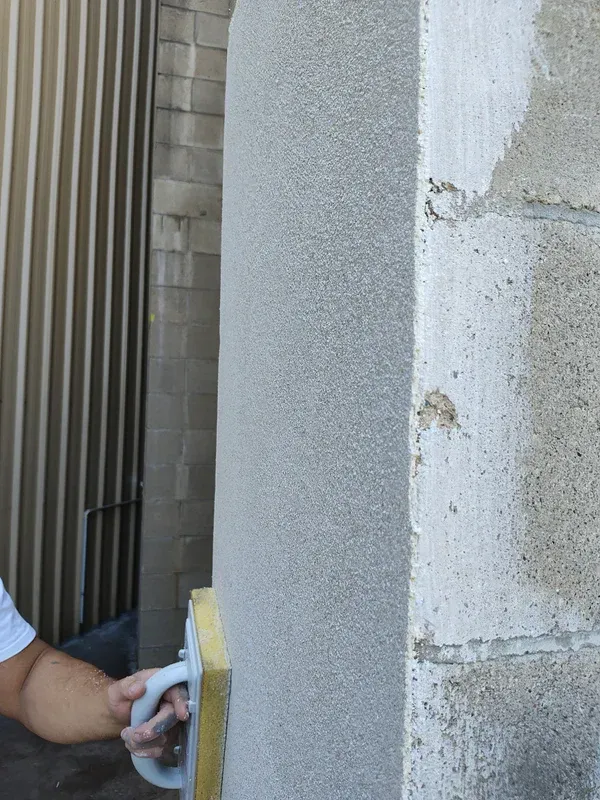 A Modern Room With a Gray Concrete Wall — Cannonvale Concrete Products in Cannonvale, QLD