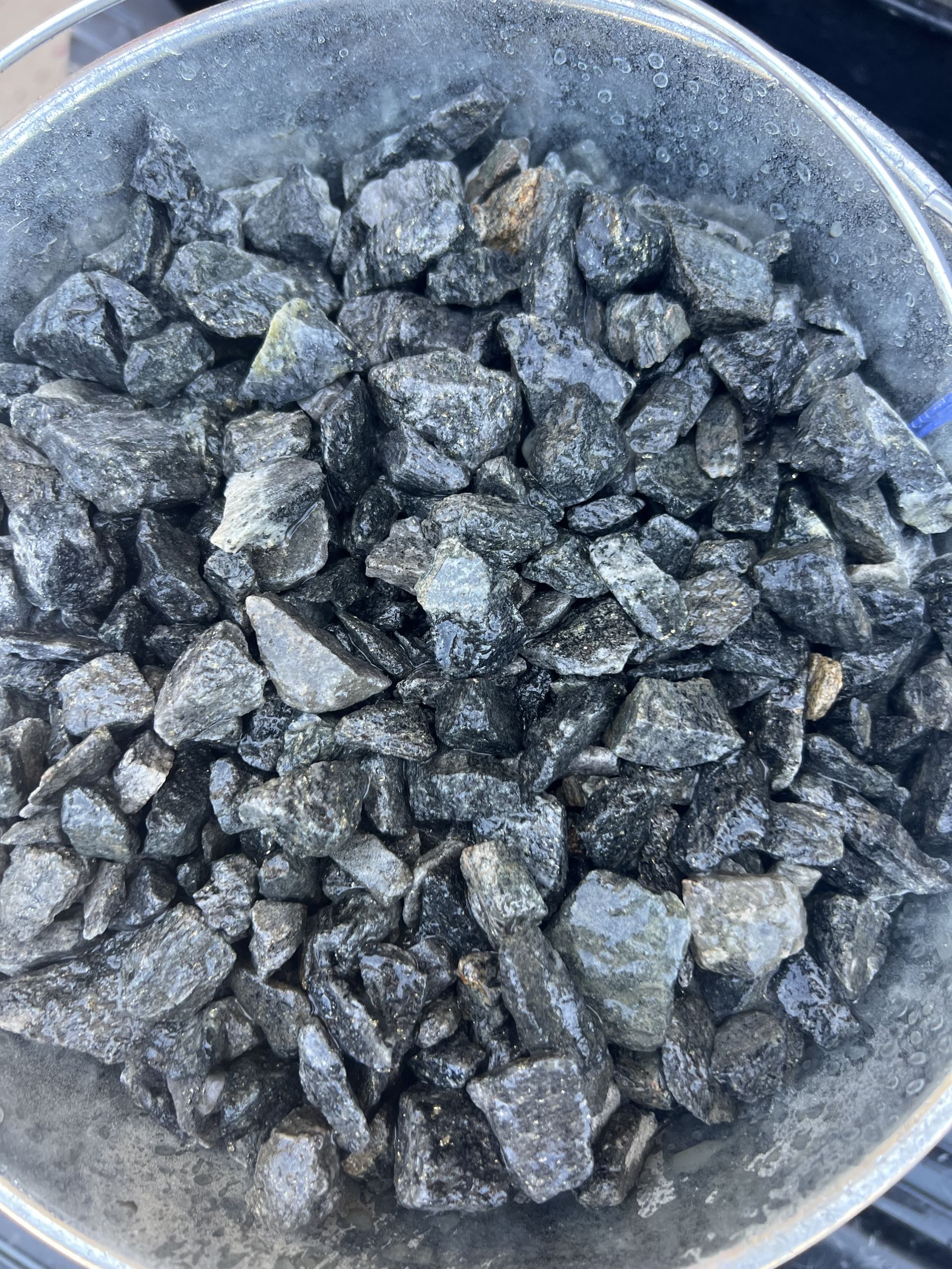 A pile of rocks is sitting on the ground.