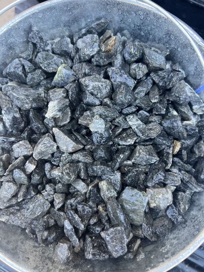 A pile of rocks is sitting on the ground.