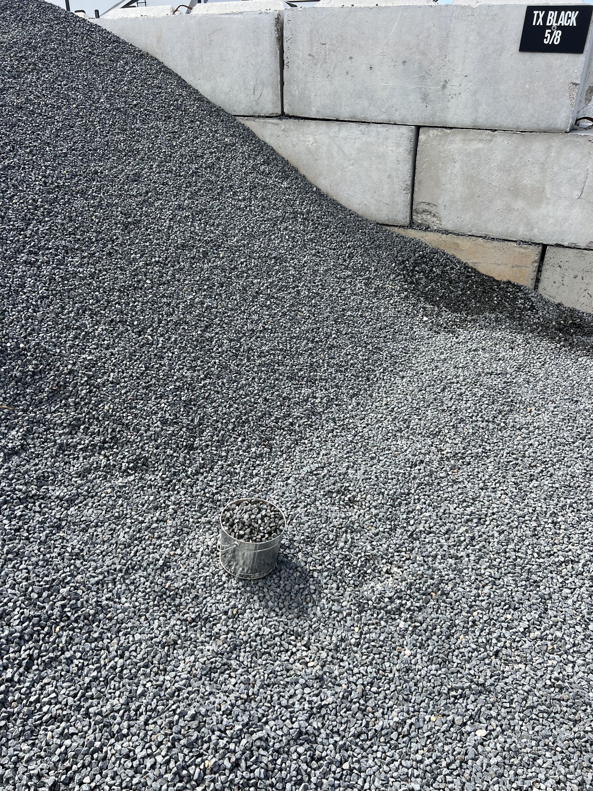 A pile of rocks is sitting on the ground.