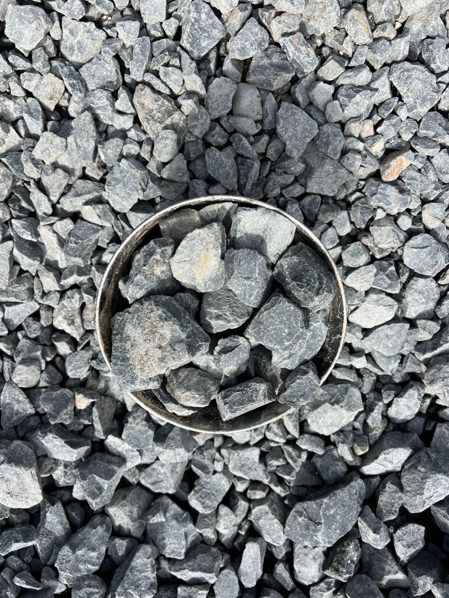 A pile of rocks sitting on top of a gravel road.